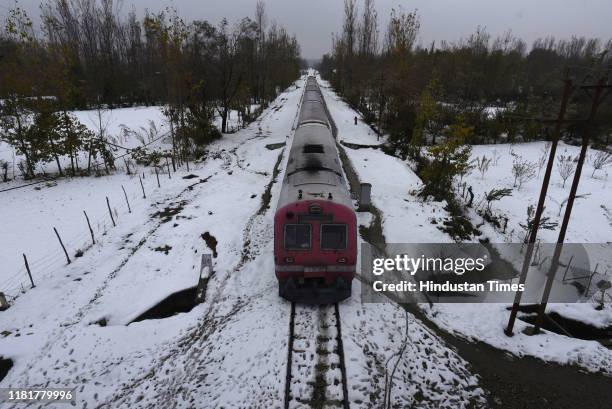 Train crosses a snow-covered railway track in Narbal area, on November 11, 2019 some 30 kilometres from Srinagar, India. Train services in the...