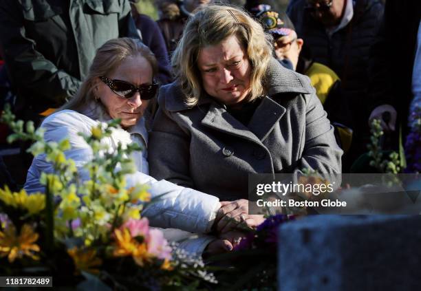 Michelle Chagaris, left, and Diane Kloepfer comfort each other during a funeral service for Chagaris' sister, Marlyse Honeychurch and her daughter...