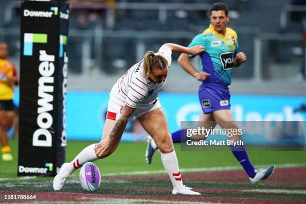 Rhiannion Marshall of England scores a try during the round one Women's Rugby League World Cup 9s match between England and Papua New Guinea at...