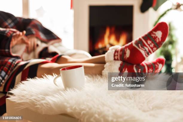 feet on christmas socks near fireplace - socks fireplace stock pictures, royalty-free photos & images