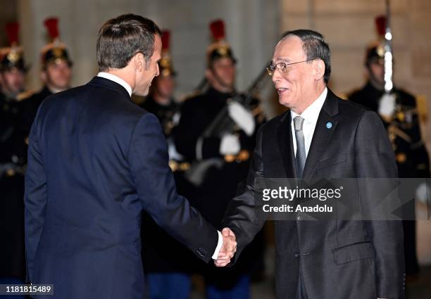 French President Emmanuel Macron welcomes Vice President of China Wang Qishan prior to a dinner with the participants of the Paris Peace Forum at the...