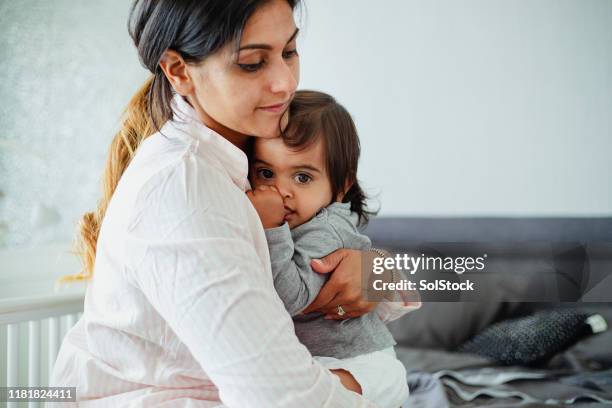 embracing her son - thumb sucking stock pictures, royalty-free photos & images