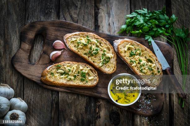 voorgerecht: knoflook brood op rustieke houten tafel - knoflook stockfoto's en -beelden