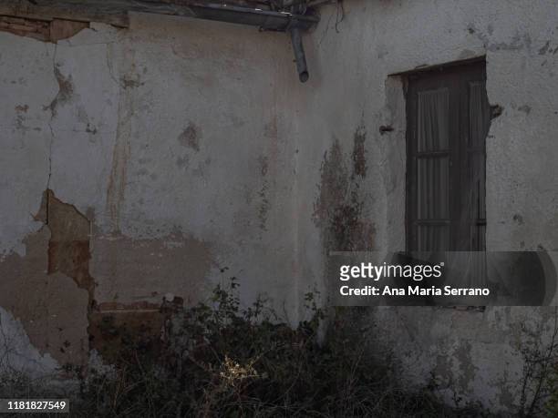 window with iron fence in an abandoned house in an abandoned city in the province of salamanca (spain). rural depopulation concept - the house of spirits stock pictures, royalty-free photos & images