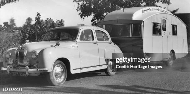 Austin A70 Hereford with caravan. Creator: Unknown.