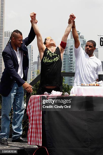 Competitive eater Takeru Kobayashi challeges 2011 Nathan's Famous Hot Dog Eating Competition Contestants via satellite at 230 Fifth Avenue on July 4,...