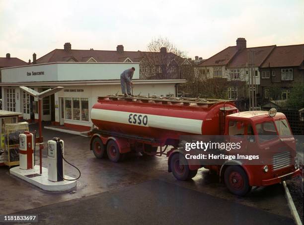 Ilford Esso petrol station with Leyland tanker making delivery 1964. Creator: Unknown.