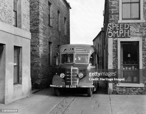 Bedford OB coach in narrow street. Creator: Unknown.