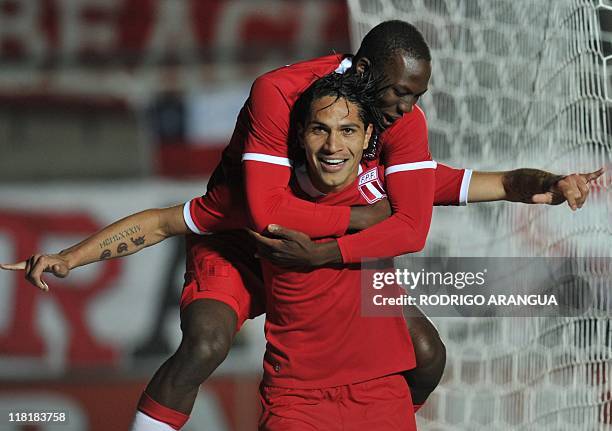 Peruvian forward Paolo Guerrero celebrates with forward Luis Advincula after opening the score against Uruguay during their 2011 Copa America Group C...