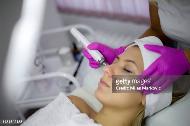 facial treatment with dermapen in the beauty salon - beauty treatment stock pictures, royalty-free photos & images