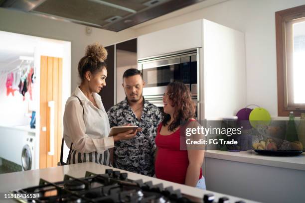 special needs couple visiting a house with a real estate agent - customer needs stock pictures, royalty-free photos & images