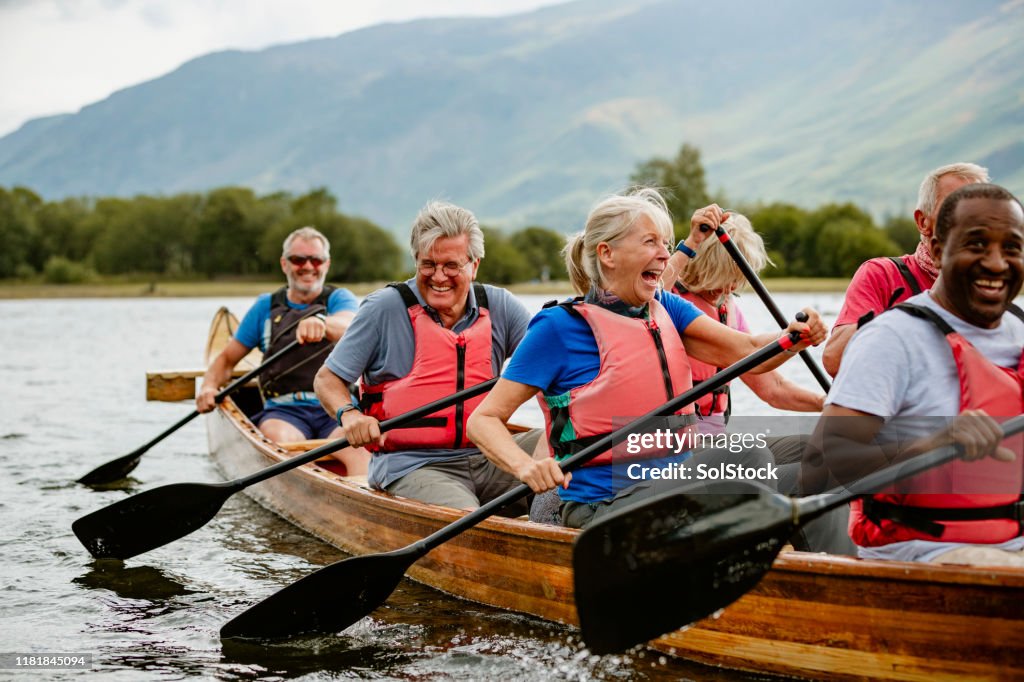 Seniors Enjoying And Having Fun In Rowing Boat