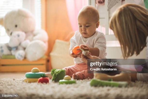 funny family time - baby rattle stock pictures, royalty-free photos & images