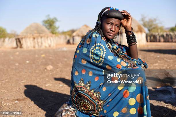 portrait of a muhacaona woman in her traditional colorful dress, oncocua, angola - angola stock pictures, royalty-free photos & images