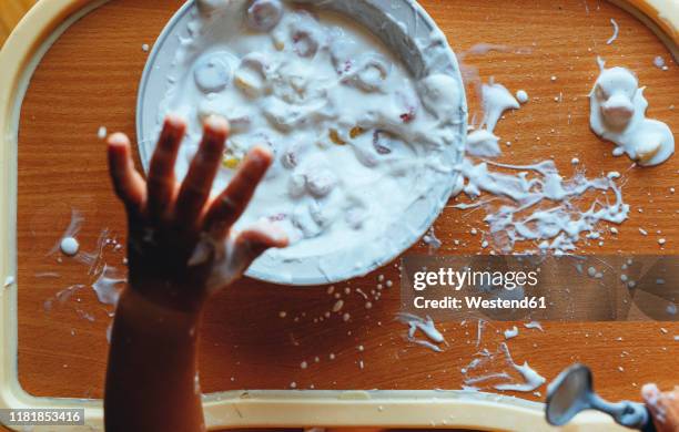 little boy eating yogurt at home, from above - breakfast table stock pictures, royalty-free photos & images