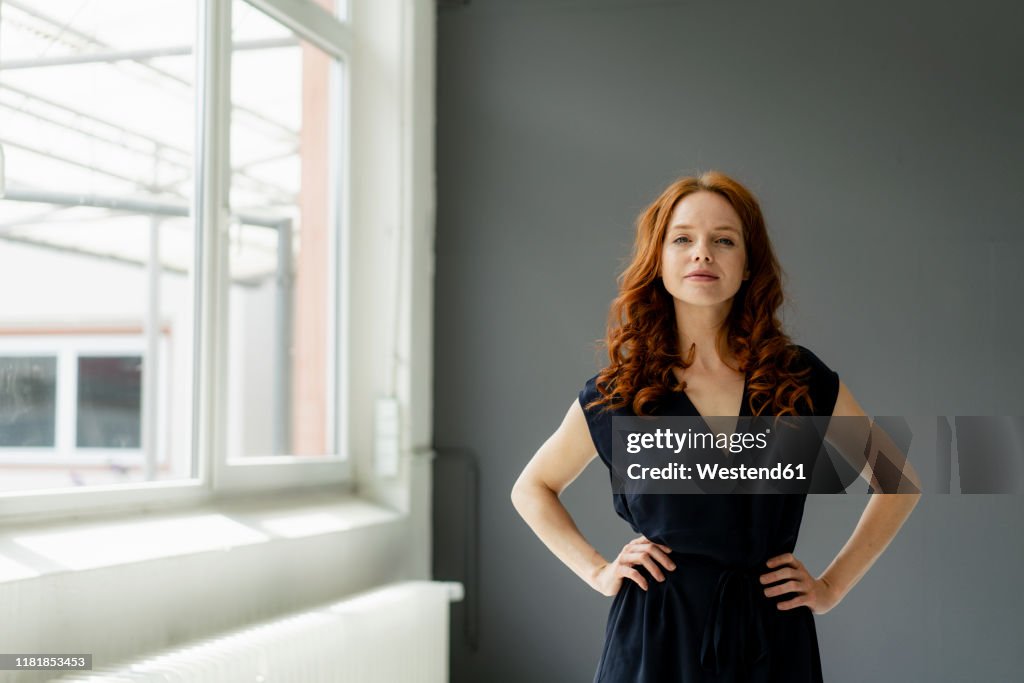 Portrait of redheaded businesswoman  in a loft