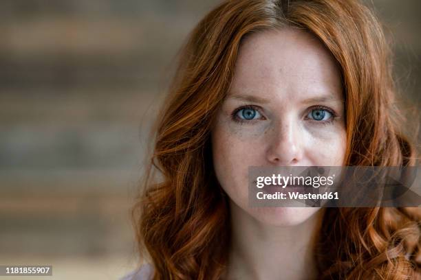 portrait of redheaded woman with freckles - redhead stock-fotos und bilder