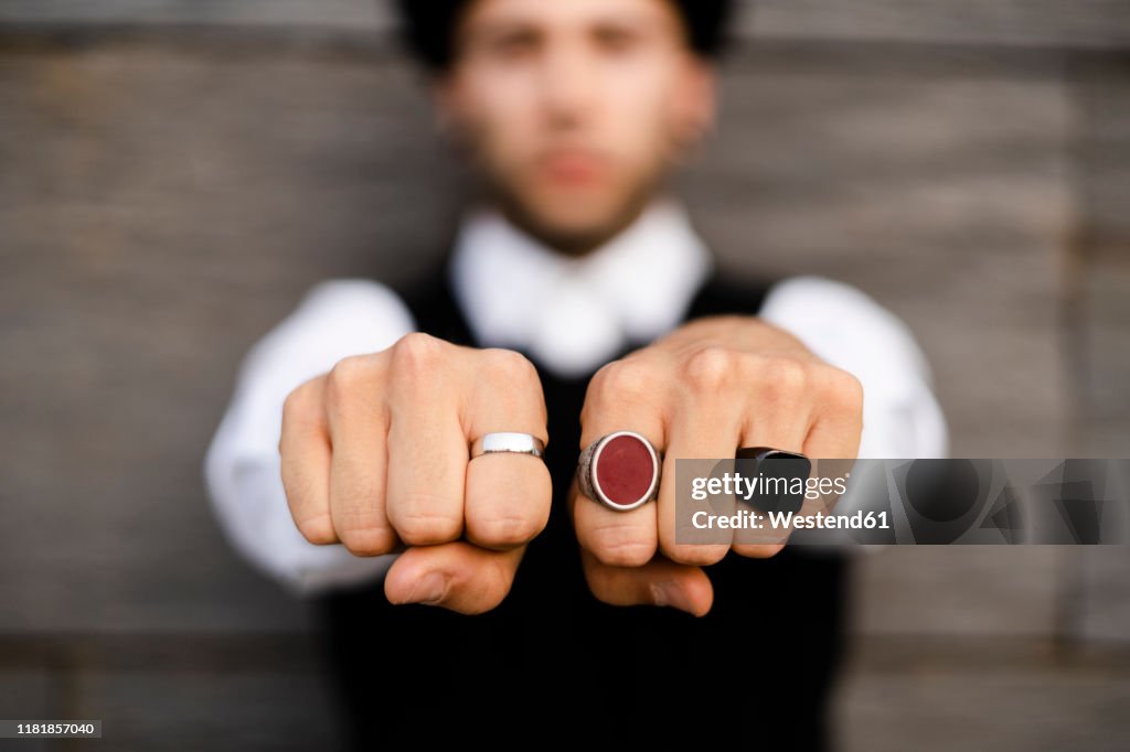 Man's hands with three various rings, close-up