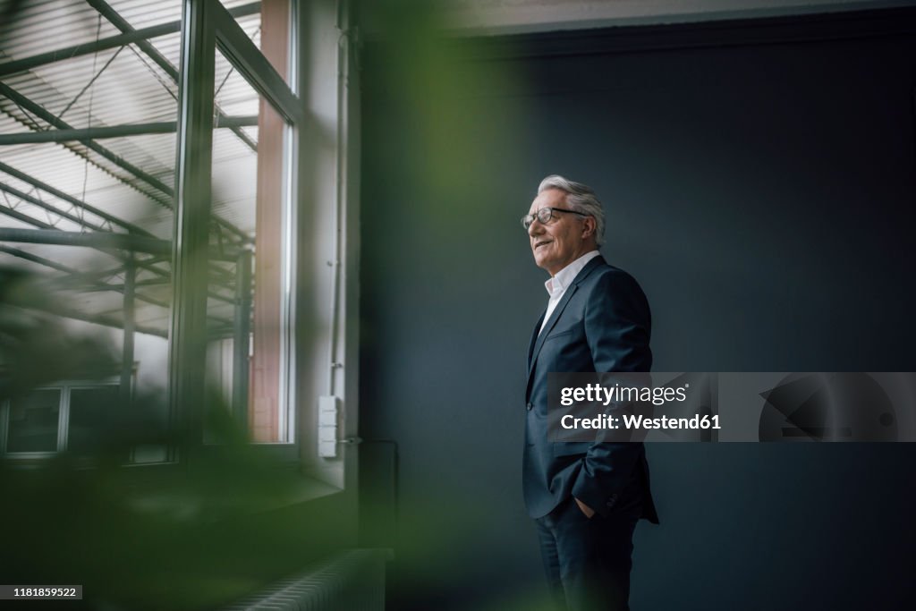 Senior businessman looking out of the window