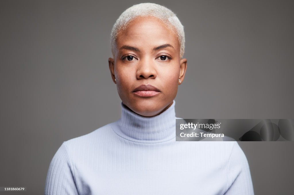 Studio headshot of a Hispanic woman wearing a turtle neck pullover.