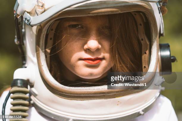 portrait of girl wearing space helmet - astronaut helm stock-fotos und bilder