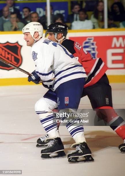 Kirk Muller of the Toronto Maple Leafs skates against Scott Niedermayer of the New Jersey Devils during NHL game action on December 10, 1996 at Maple...