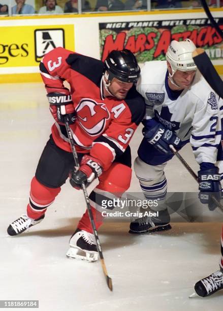 Ken Danyko of the New Jersey Devils skates against Kirk Muller of the Toronto Maple Leafs during NHL game action on December 10, 1996 at Maple Leaf...