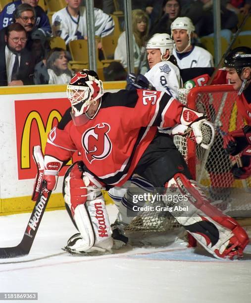 Richard Brodeur of the New Jersey Devils skates against Todd Warriner and Doug Gilmour of the Toronto Maple Leafs during NHL game action on December...