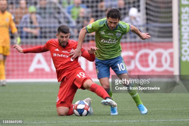 Seattle Sounders midfielder Nicolas Lodeiro and Toronto FC midfielder Alejandro Pozuelo battle for the ball during the MLS Championship game between...