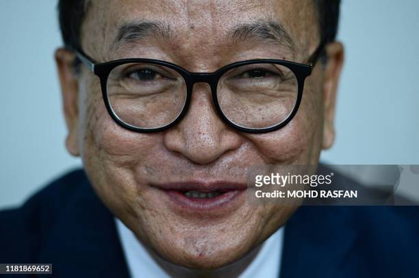 Cambodia's exiled opposition figurehead Sam Rainsy, who leads the Cambodia National Rescue Party , speaks during an interview with Agence...