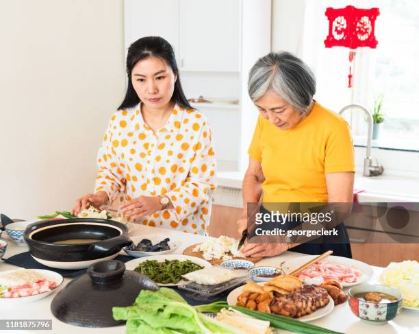 celebrating chinese new year together - chinese prepare for lunar new year stock pictures, royalty-free photos & images