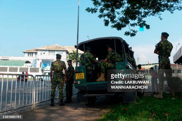 Special Task Force soldiers stand guard near the Welikada prison in Colombo on November 12 as inmates protest the pardon for a man who murdered a...