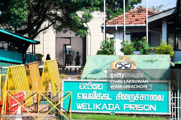 Prison guards secure the main entrance of the Welikada prison in Colombo on November 12 as inmates protest the pardon for a man who murdered a...