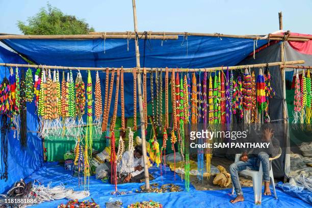 Stall holder selling accessories meant for handling camels waits for customers during a Cattle Fair near Saraswati river bank at Siddhpur, some 120...