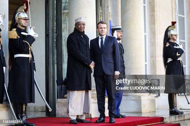 France's President Emmanuel Macron welcomes Chad's President Idriss Deby as he arrives at the Elysee presidential palace for a lunch as part of the...