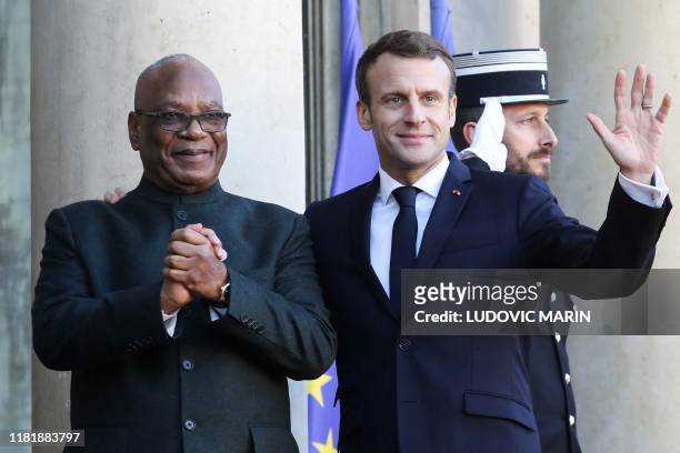 France's President Emmanuel Macron welcomes Mali's President Ibrahim Boubacar Keita as he arrives at the Elysee presidential palace for a lunch as...