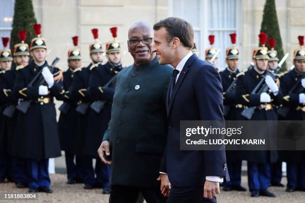 France's President Emmanuel Macron welcomes Mali's President Ibrahim Boubacar Keita as he arrives at the Elysee presidential palace for a lunch as...