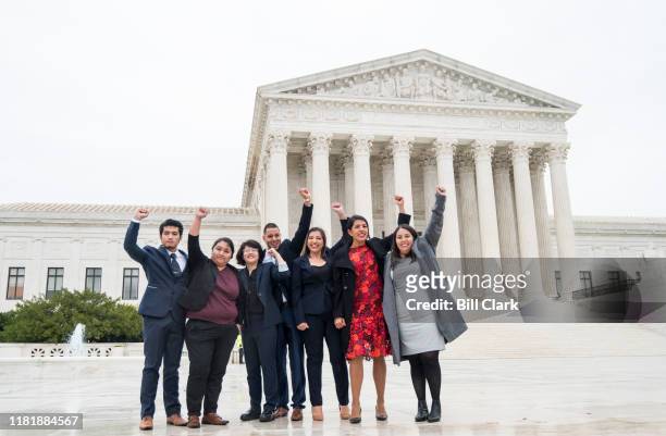 Recipients, including Carolina Fung Geng, , plaintiff Martin Batalla Vidal and Eliana Fernández hold their fists in the air as they enter the U.S....
