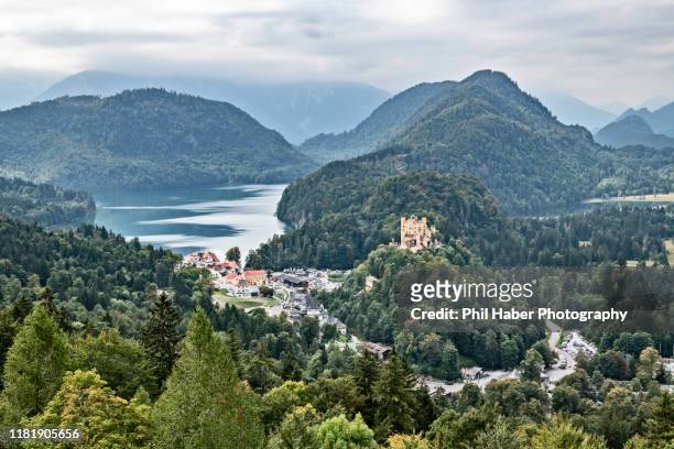 view of schwangau on a foggy day - hohenschwangau castle stock pictures, royalty-free photos & images