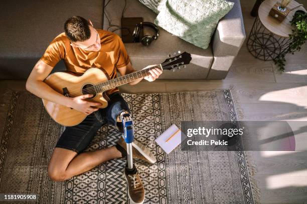 his passion is music - amputee home stock pictures, royalty-free photos & images