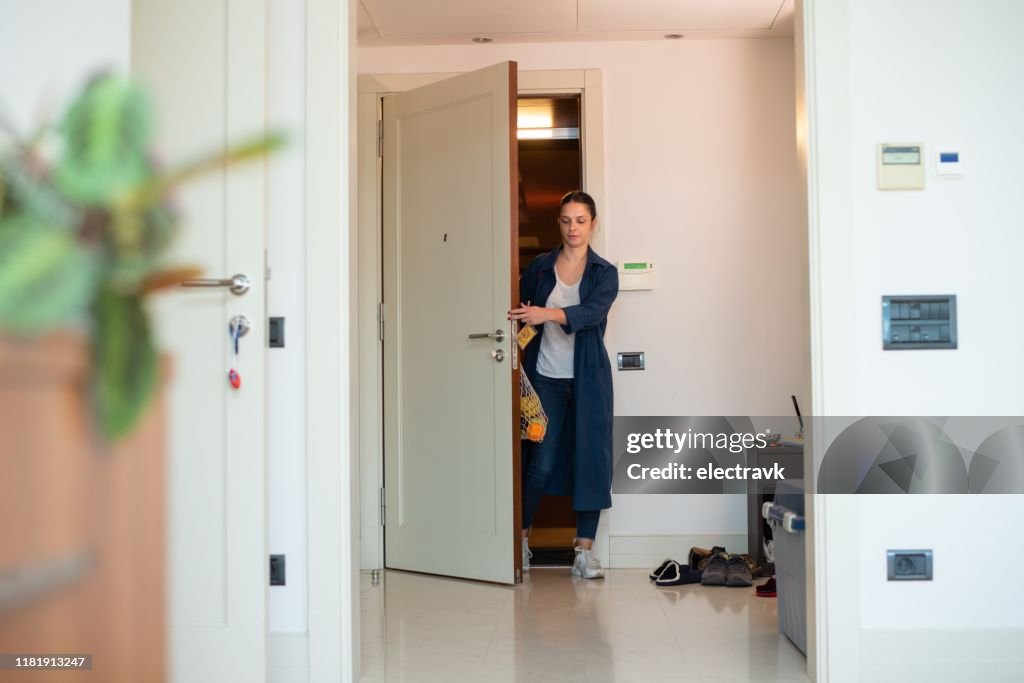Woman coming home after grocery shopping