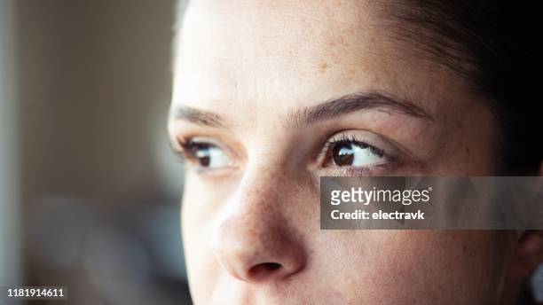 closeup of woman looking away - serious face stock pictures, royalty-free photos & images