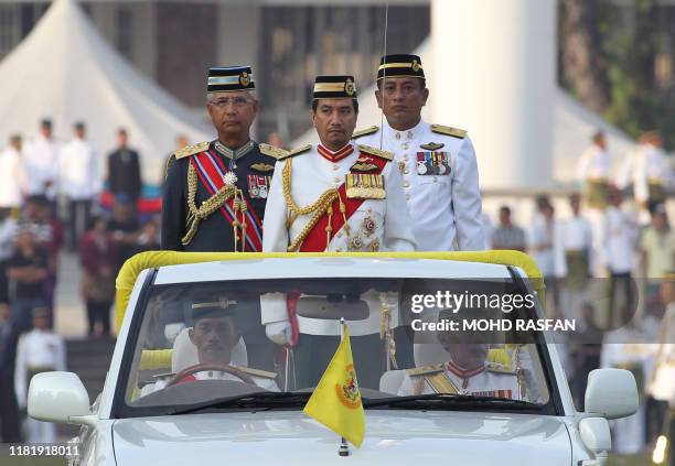 Malaysia's King Sultan Mizan Zainal Abidin and Malaysian chief of the Defence Force General Azizan Arifin inspect a honour guard in Kuala Lumpur on...