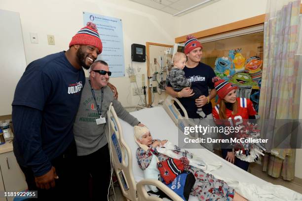 New England Patriots Shilique Calhoun, Ryan Izzo, and cheerleader Alexis Melvin visit with Michael and family at Boston Children's Hospital November...