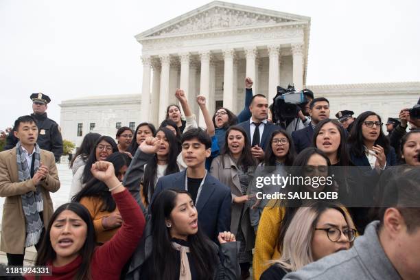 Plaintiffs come out of court as immigration rights activists hold a rally in front of the US Supreme Court in Washington, DC, November 12 following...