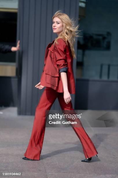Katherine McNamara is seen wearing a Natalie Tre suit, Zeynep Arcay tank-top with Sam Edelman shoes and Ratio Et Motus handbag in the Financial...