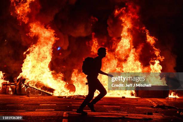 Fires burn following an evening of rioting as a general strike is called after a week of protests over the jail sentences given to separatist...