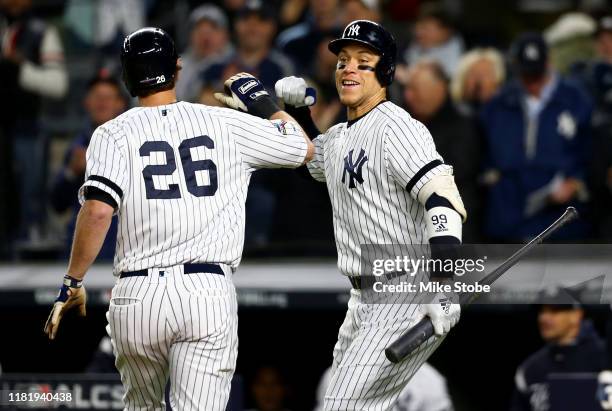 LeMahieu of the New York Yankees celebrates with Aaron Judge after hitting a solo home run against Justin Verlander of the Houston Astros during the...