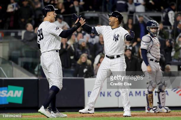 Aaron Hicks of the New York Yankees celebrates with Aaron Judge after hitting a three run home run against Justin Verlander of the Houston Astros...