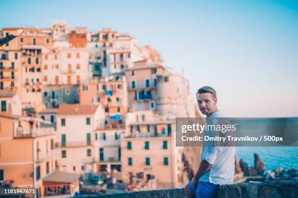 tourist looking at scenic view of manarola, cinque terre, liguria, italy - liguria imagens e fotografias de stock